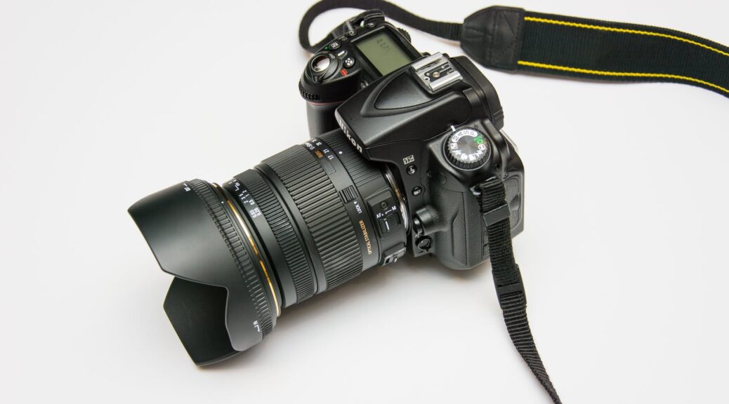 black dslr camera on white surface