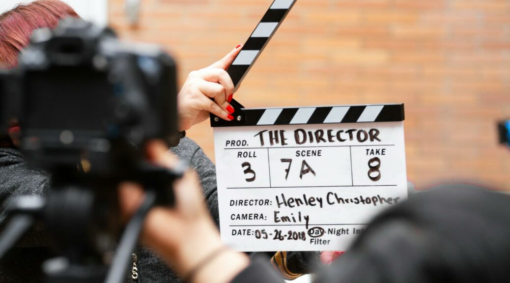 man holding clapper board